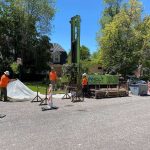 Photo of a sonic well drill rig being set up in a residential neighborhood.