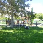 Photo of a monitoring well drill rig with safety fencing in a public park.